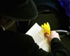 An attendee of Rabbi Hendel Weingarten's Purim service at Chabad House on Elizabeth Street in East Lansing uses a noisemaker after the name of Haman is read. Purim is a Jewish holiday that celebrates the deliverance of the Jews from an evil plot conceived by Haman, as chronicled in the Megillah, or book of Esther. Rabbi Mordechai Haller read the Megillah to a group including about 15 MSU students who would blot out the name Haman using noisemakers each time it was read.